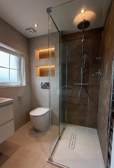 En-suite with bronze feature tiling, walk-in shower and illuminated niches